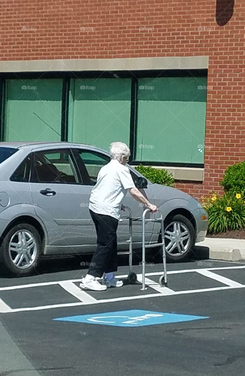 Lady with walker, handicapped parking.