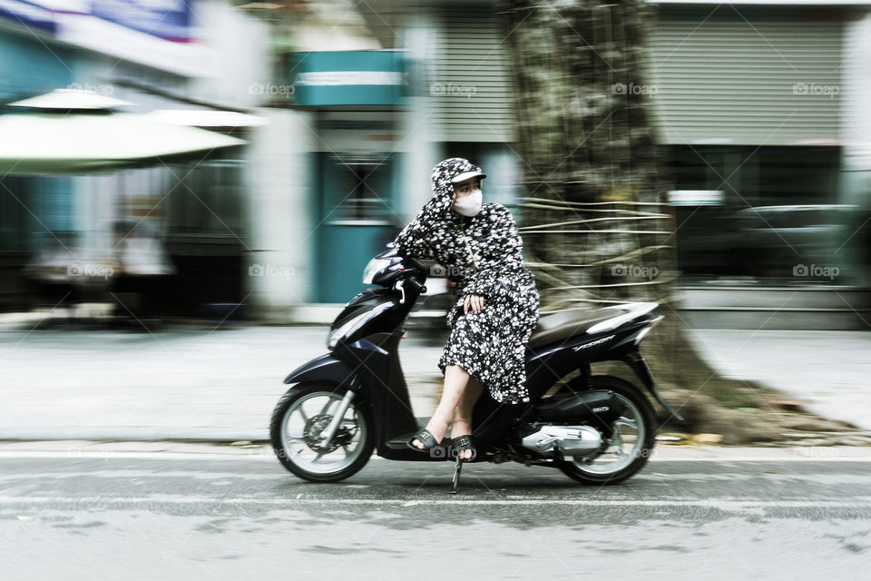Woman on motor bike.