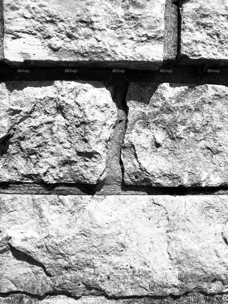 Black and white closeup of the stone bricks that house our huge fire pit for winter fires. 