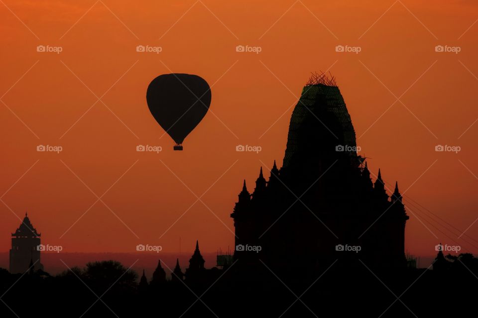 Balloon in the golden twilight over pagoda field in Bagan Myanmar