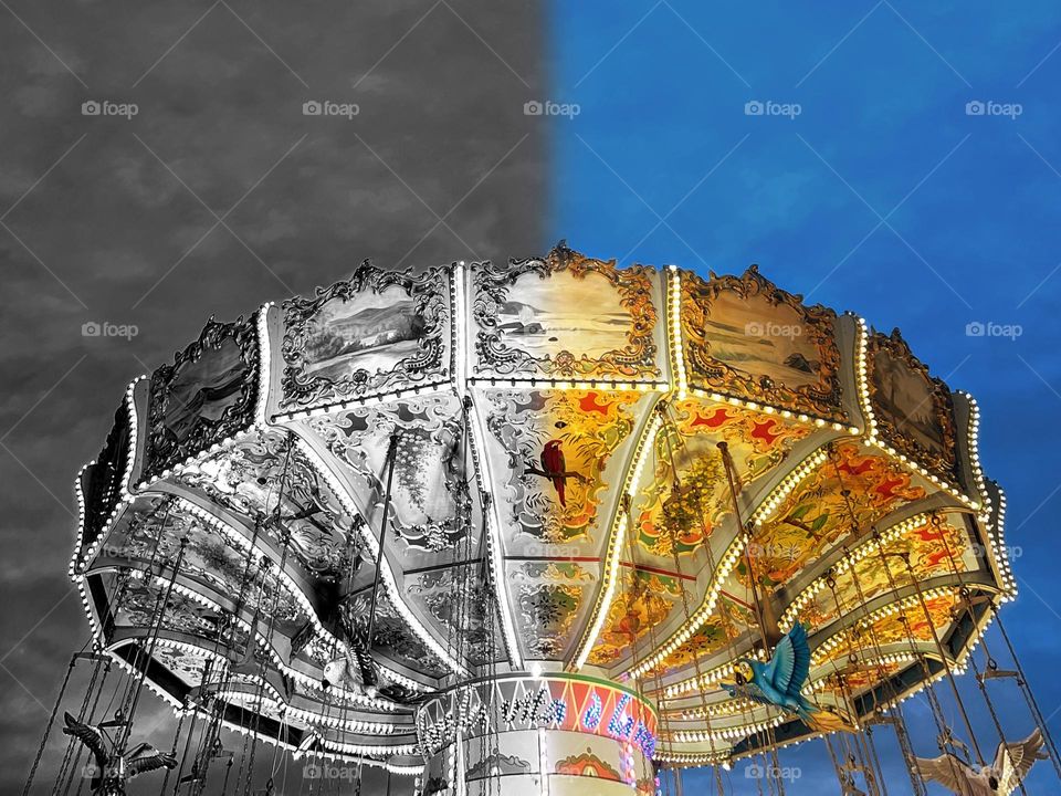 Chain carousel in the evening half black and white, half colorful