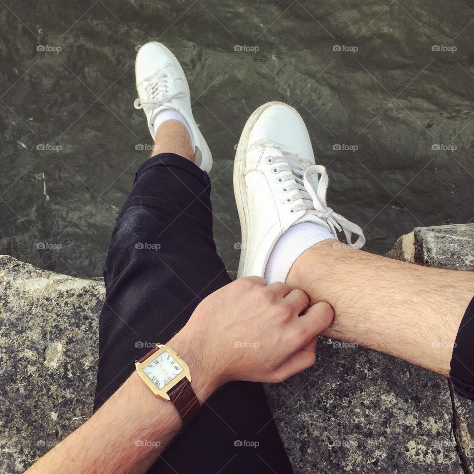 White sneakers and watch over the river 