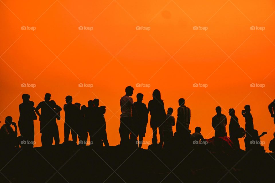 A silhouette of a crowd gathered at sun rise point or Kanniyakumari beach 