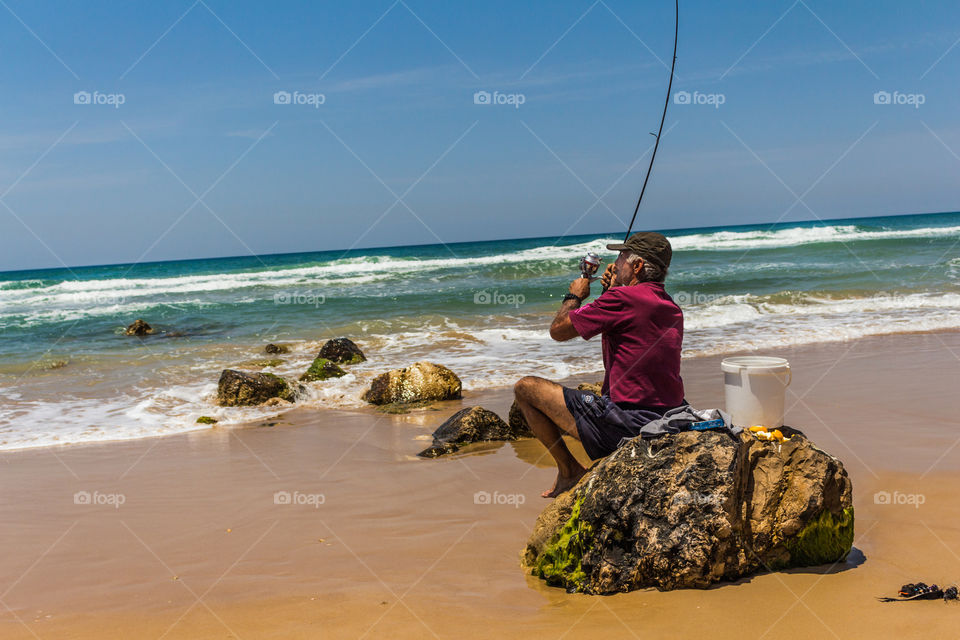 Man fishing by the sea