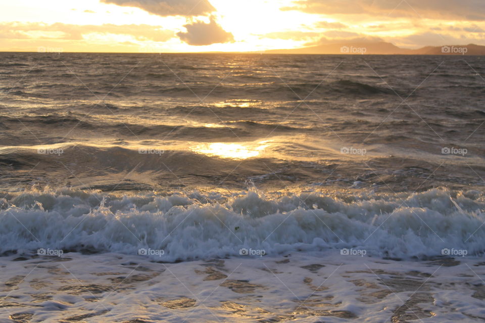 Some sunrise shots of the ocean on a windy Pacific Northwest morning. The high tide created frothy waves breaking on the shore. There were some clouds but the sun shone through creating beautiful colour in the sky and sea.