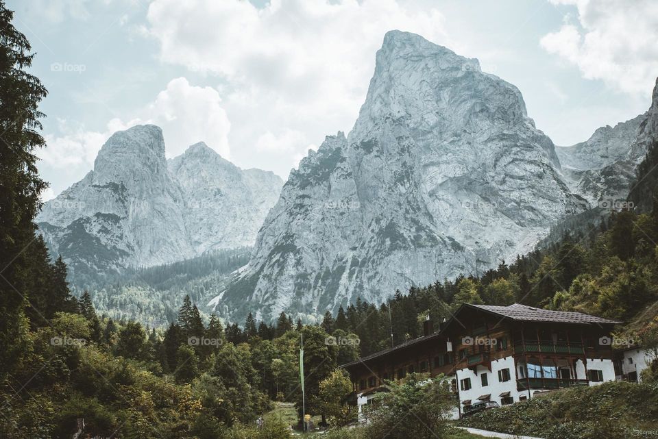Here you can see a big mountain with snow and a small house