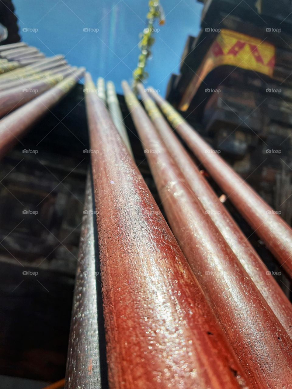 red bamboo poles lying horizontally on the wall