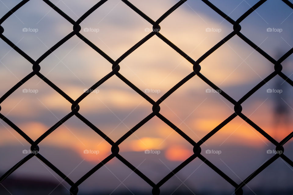 Metal cage square channel on beautiful sunset nature background