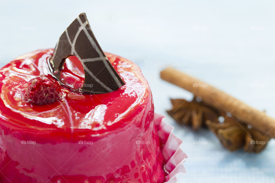 red cake with chocolate and raspberry on a blue background.  desert is the best part os eating!