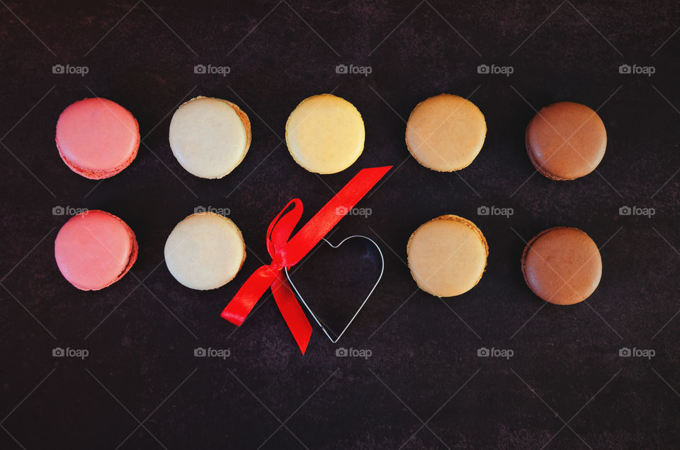 Festive dark background. Colorful macaroons. Valentine's day. 14 of February. Flat lay. Top view. Gift ideas.