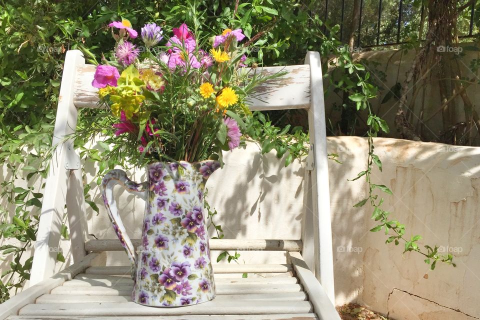 Wild flowers in a vase in a garden