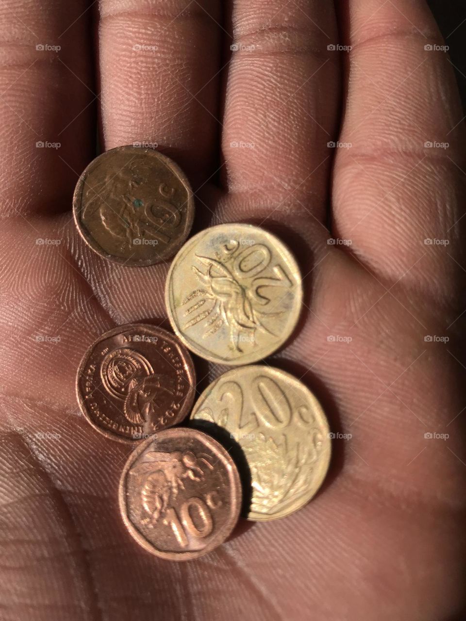 The vibrant colors and clear focus make this image truly eye-catching. The light reflects off the surfaces of the coins, creating a stunning visual effect that is bothattractive and engaging.