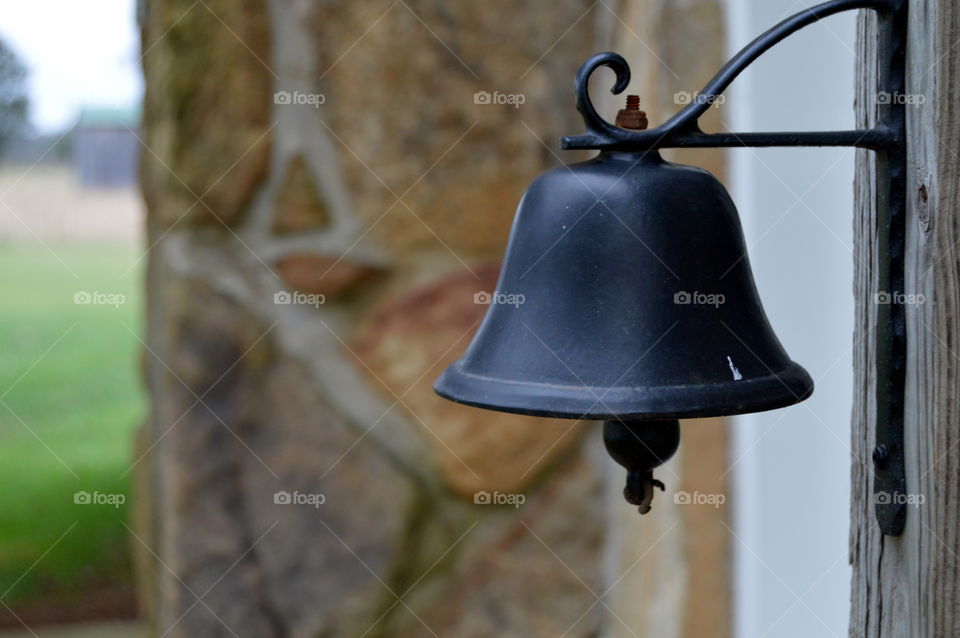 Hanging bell on farmhouse.