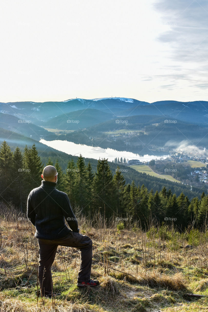 a man enjoys the view in the mountains