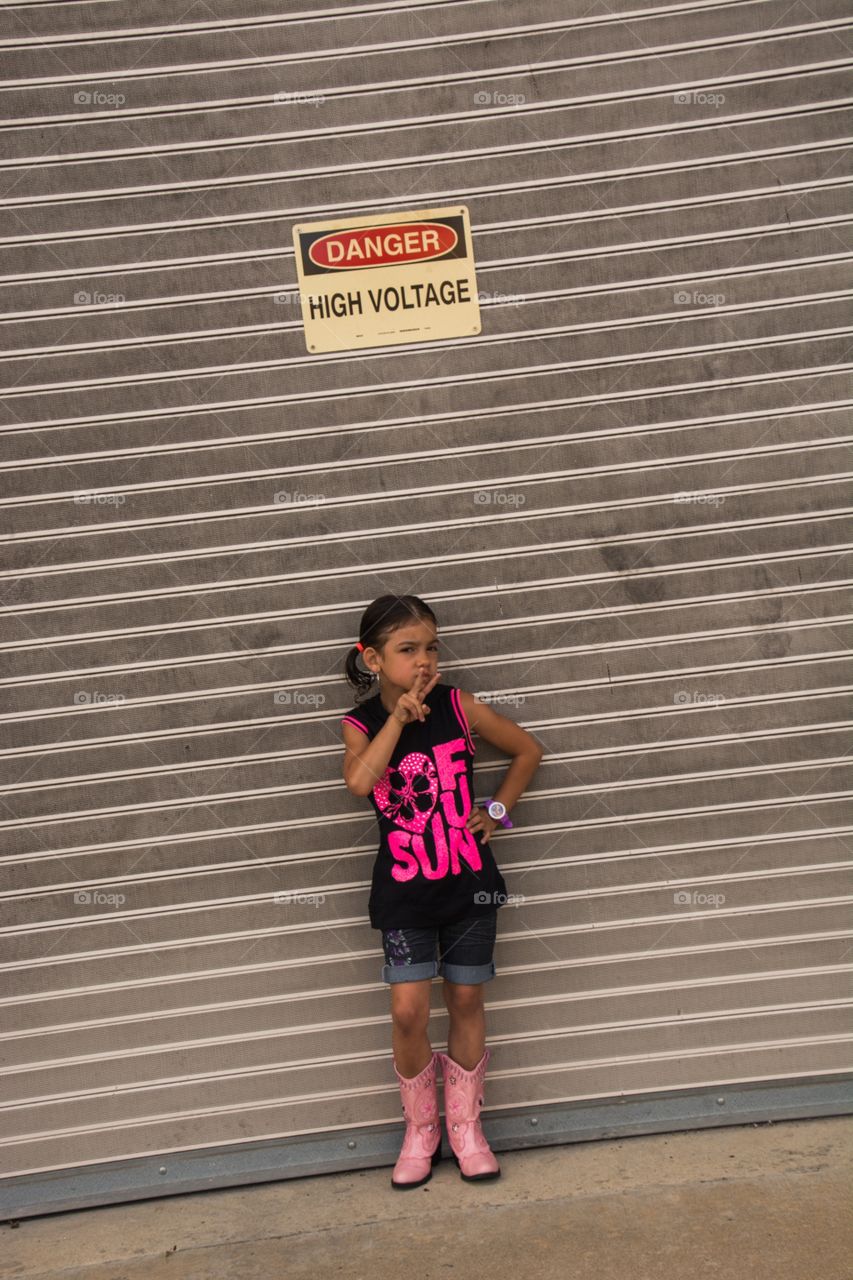 Little girl posing in front of a garage door in Nashville
