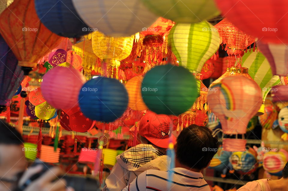 Everyone is choosing/buying color lanterns in shop for Mid-autumn festival in Vietnam