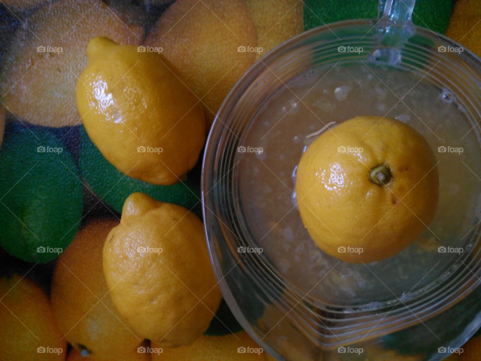 Juicing lemons. Getting fresh lemon juice for lemonade.