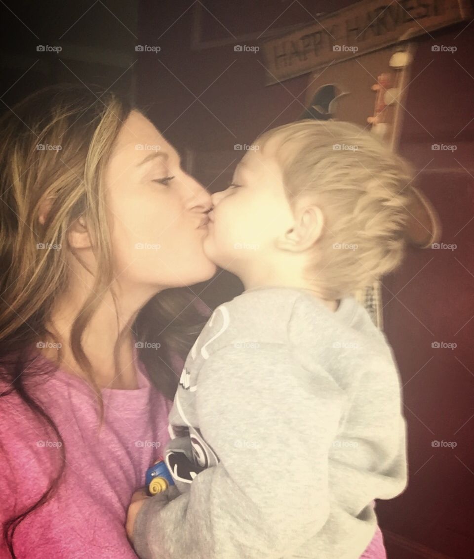 Kissing mommy. 