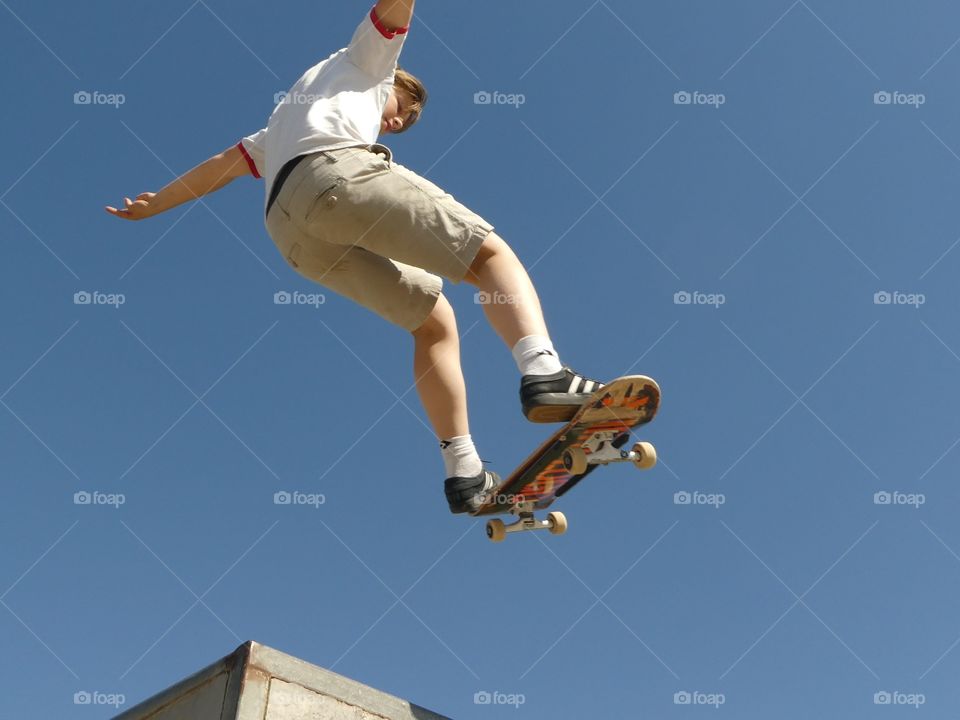 Flying skateboard blue sky