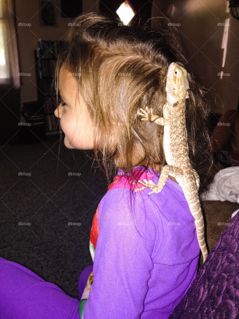 My daughter with her brother's bearded dragon, Spike.