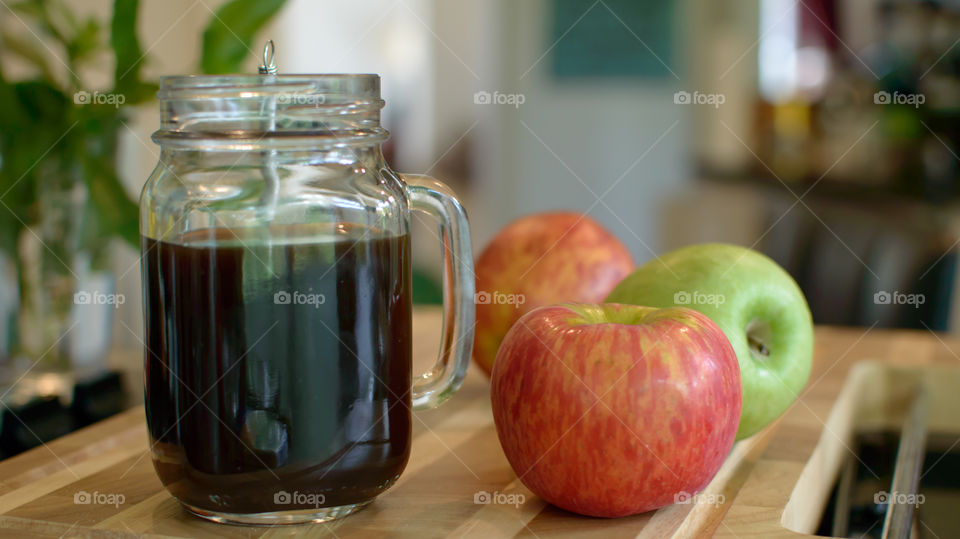 Healthy red and green apples on wood table in kitchen next to fresh black coffee in glass mug conceptual healthy choices    And self care tranquil lifestyle background photography 