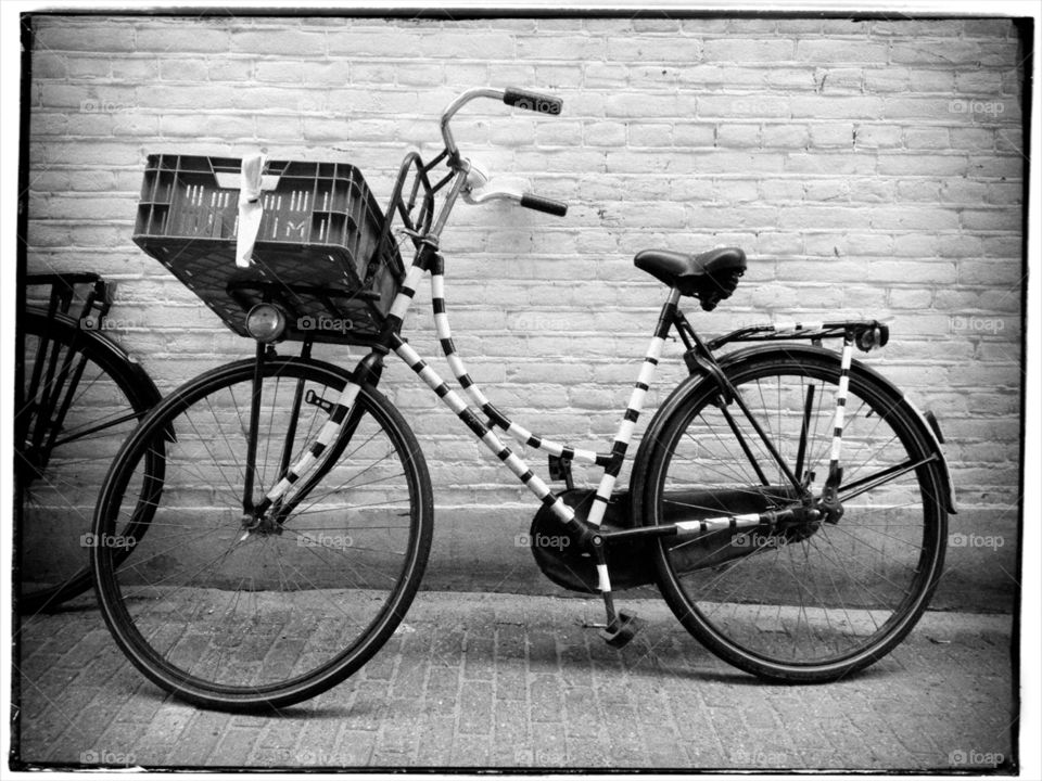 An old style bicycle parked in the street
