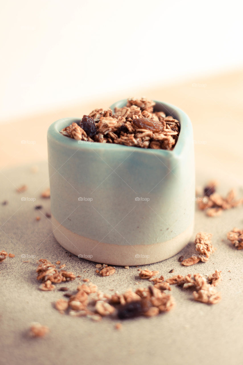 Yum yum granola. Yummy healthy granola in a ceramic heart container.