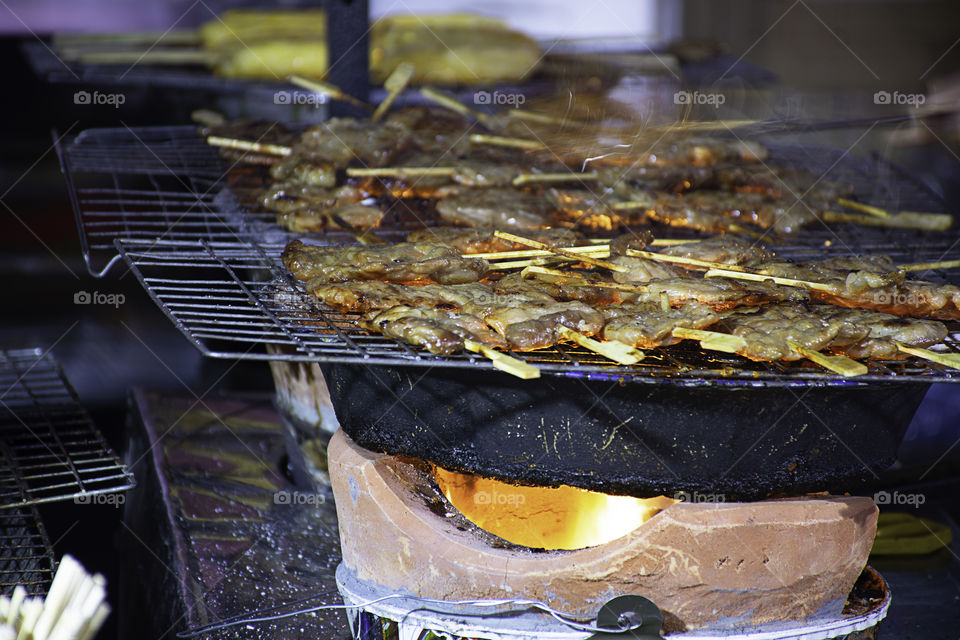 Grilled marinated pork with sauce Skewers and small on the steel grilles With the heat.