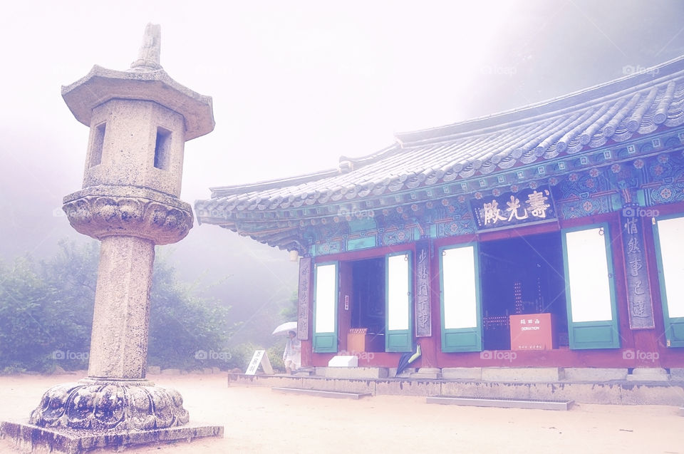 Buddhist temple in South Korea with foggy background in the forest