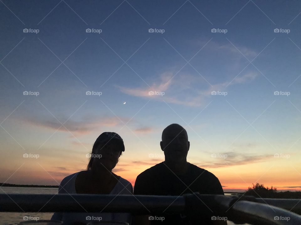 Taking a boat ride with my man after a day of fishing, with the beautiful Texas sunset and the moon behind us 🌙