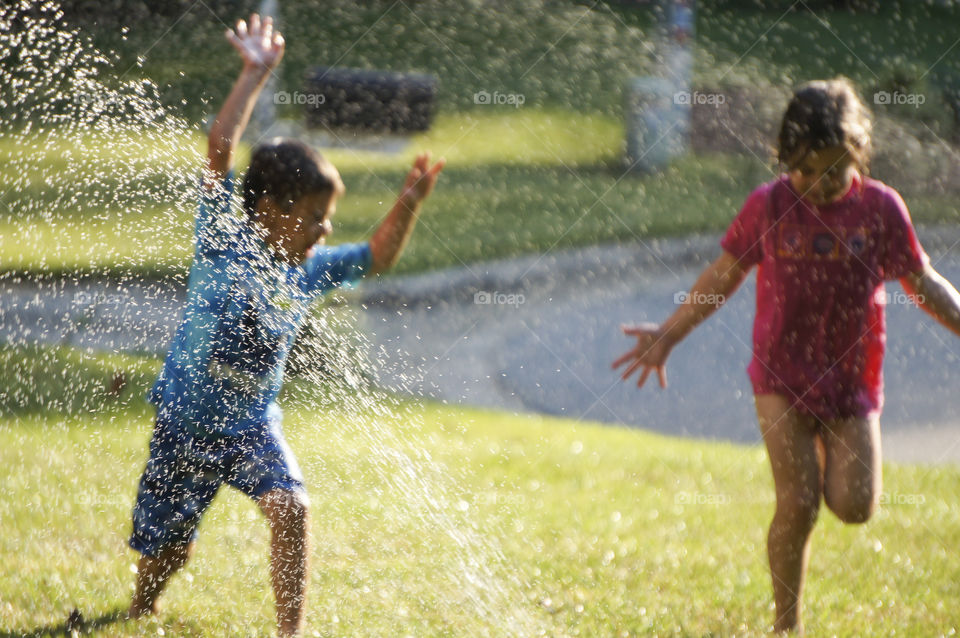 Playing In The Sprinkler In The front yard