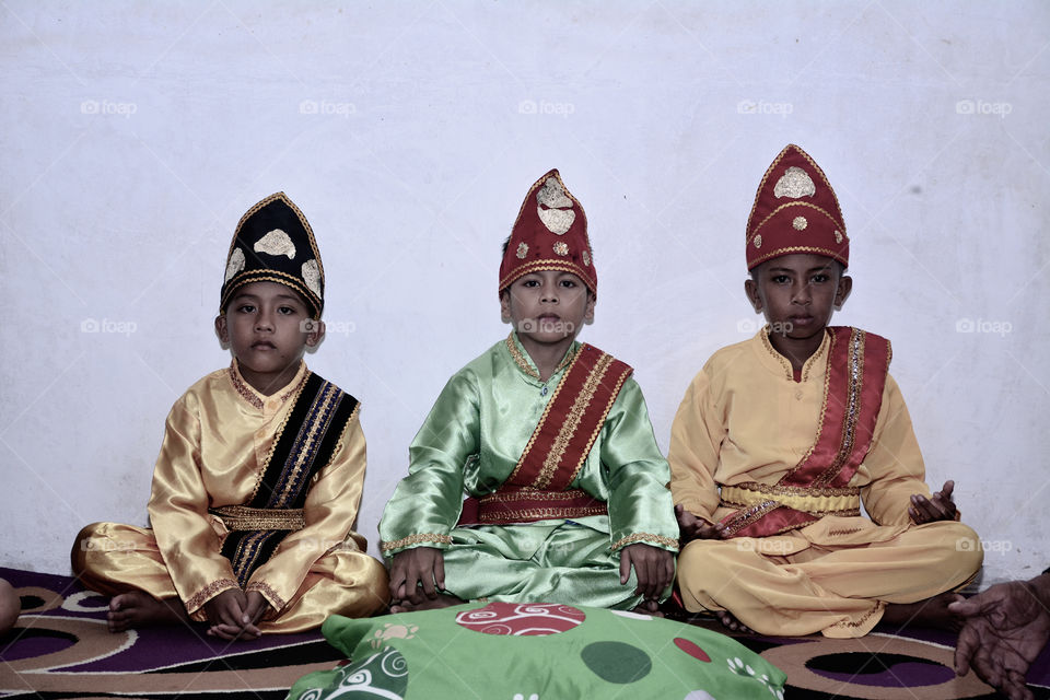 three boy wearing traditional clothes