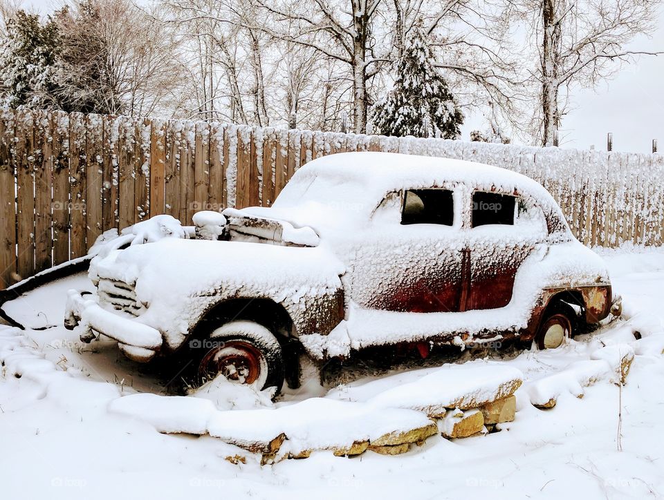 snow covered abandoned rustic car