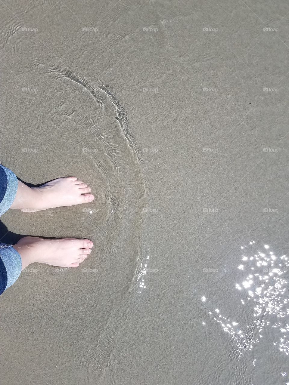 Feet in beach water