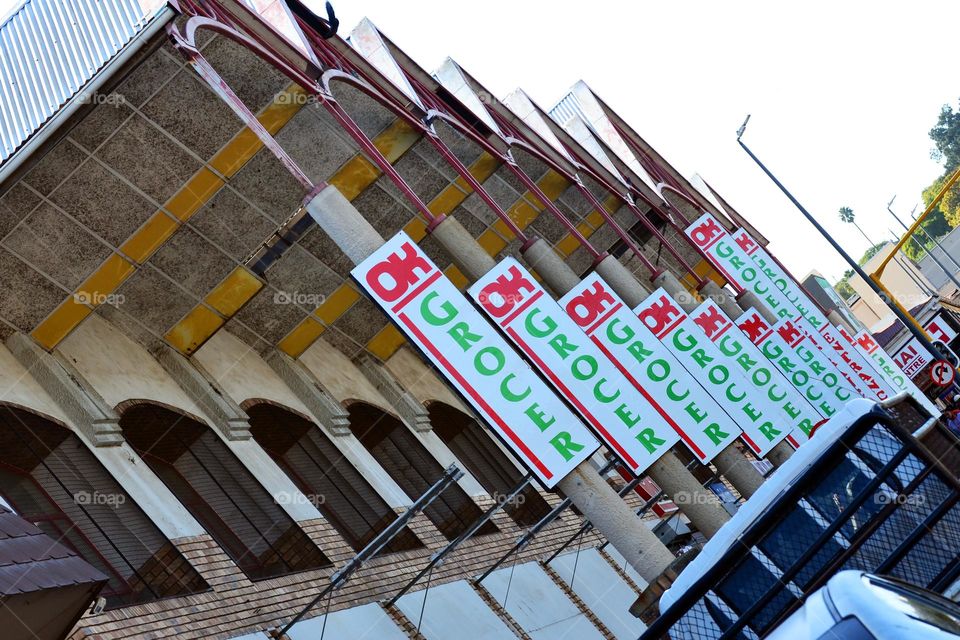 Multiple Ok grocer advertisement poster boards in sequence