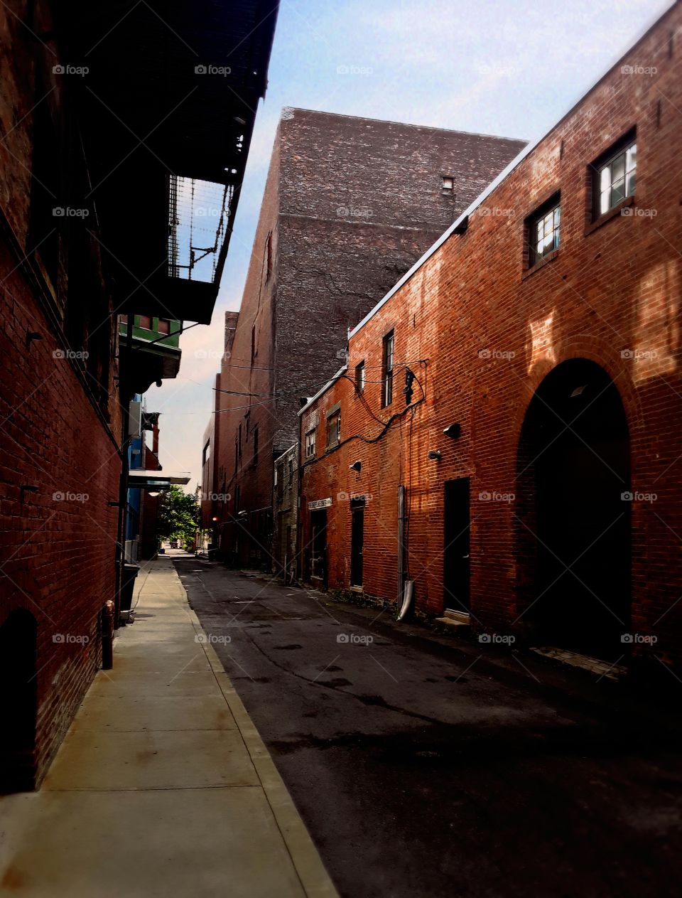 Alley with very old buildings and sunlight reflections
