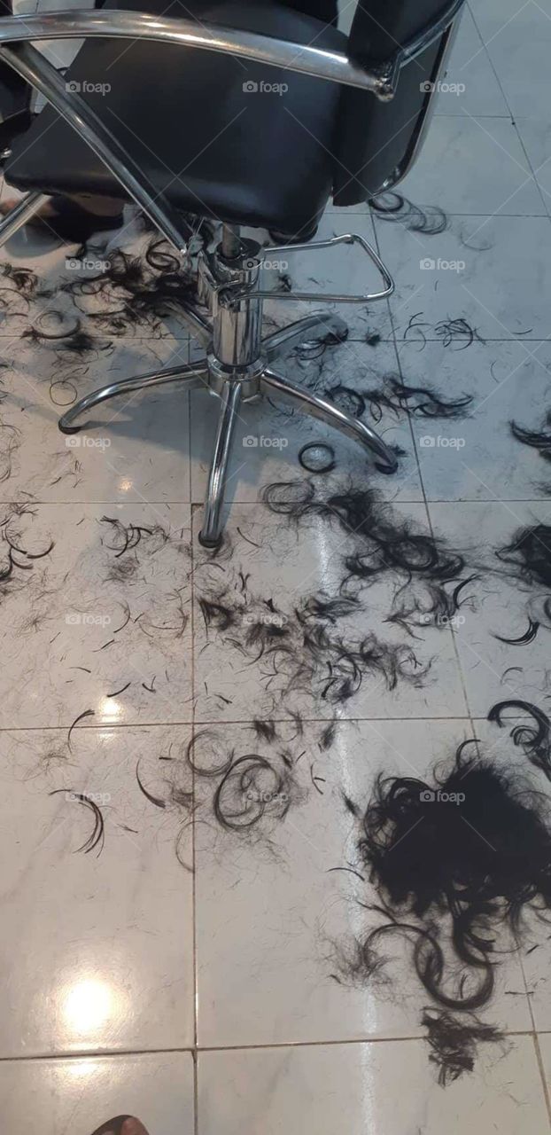 A photo of an actual hair cut on the floor of a salon.