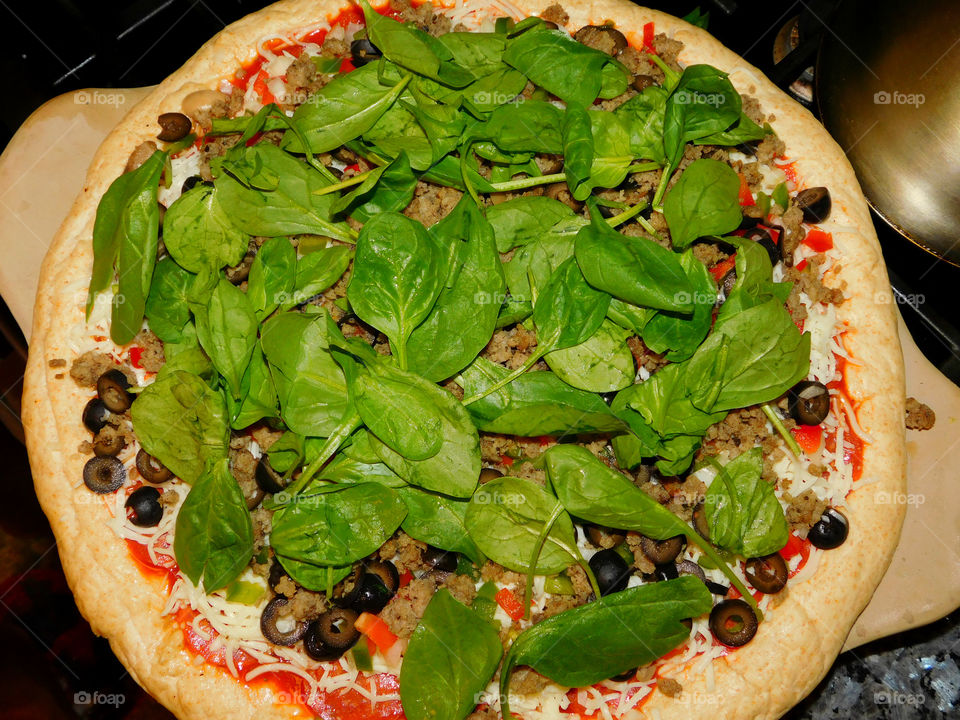 Delicious and nutritious homemade pizza with fresh, colorful vegetables, meats and a variety of spices! Grab a slice!