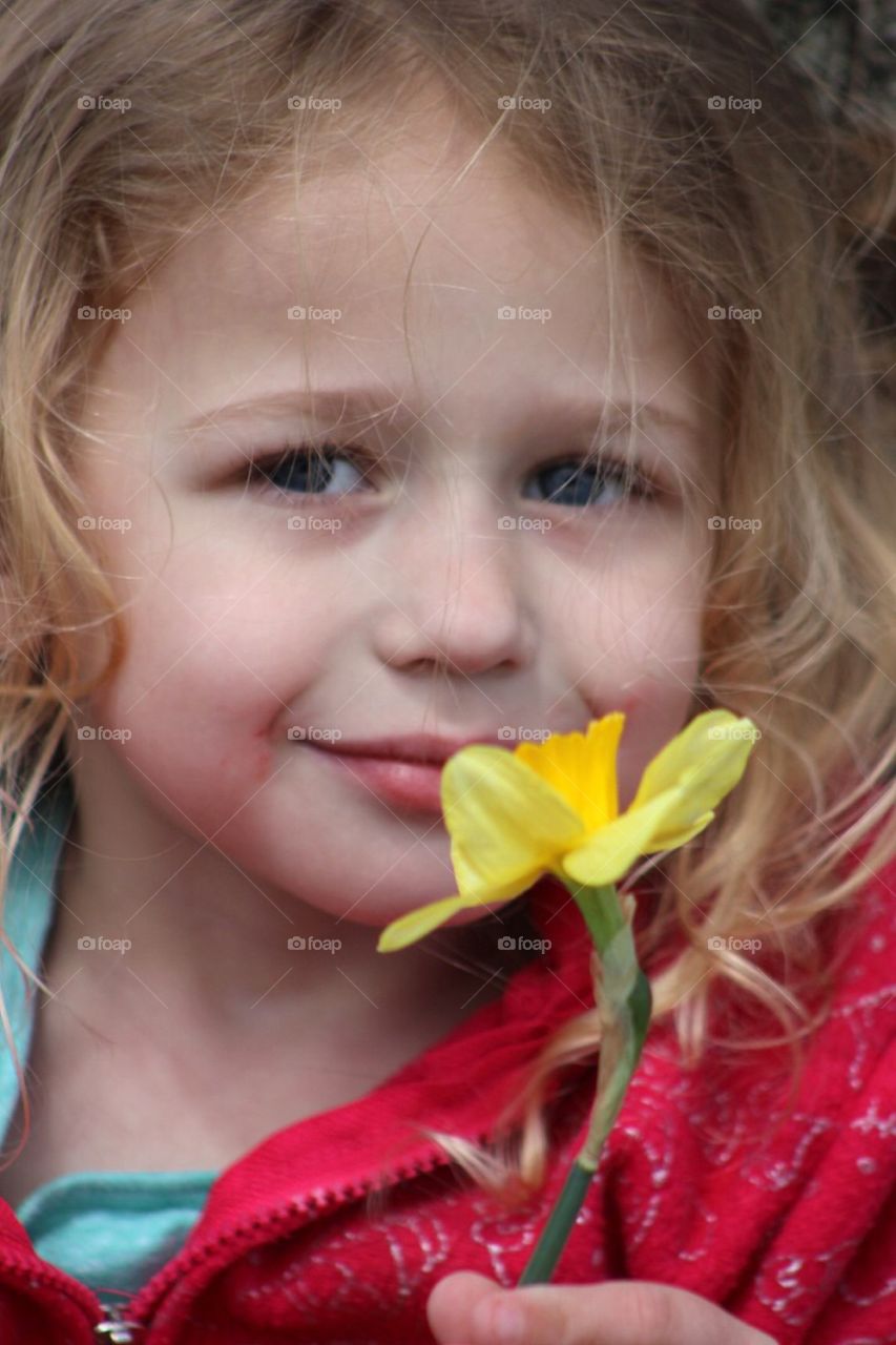 My beautiful daughter smelling a freshly picked daffodil. 
