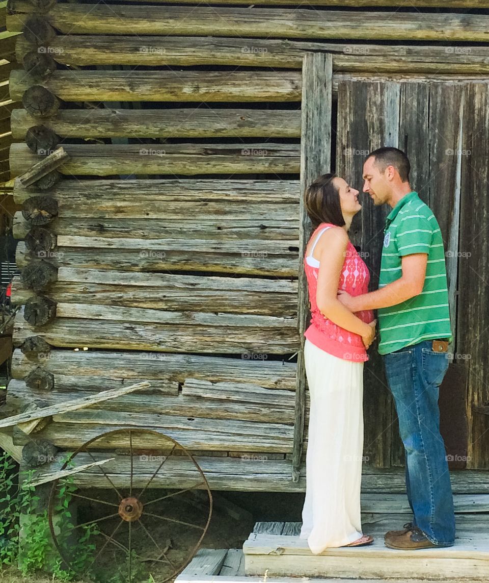 Loving couple in front of old cottage