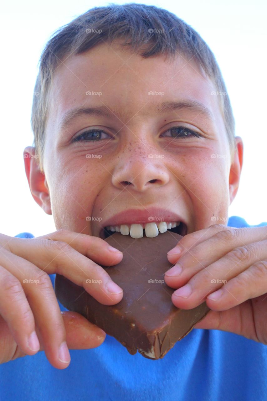 Portrait of a boy eating chocolate