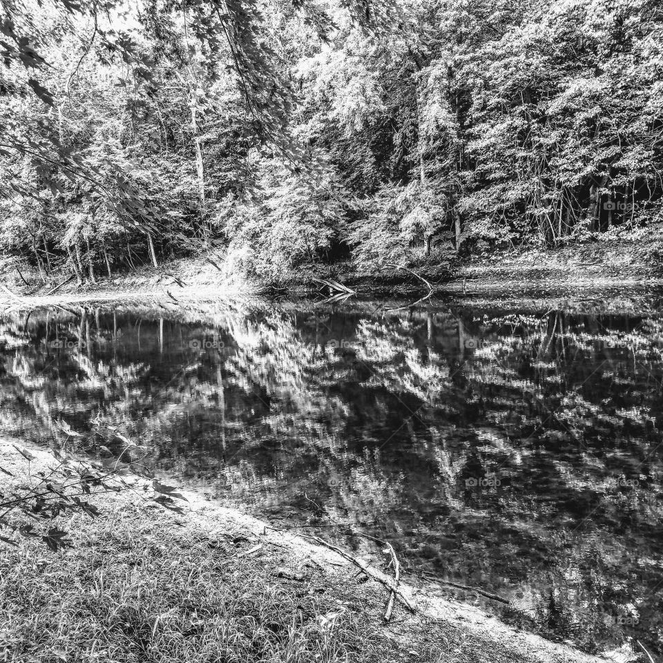Lazy Grand River on a hot summer's day mirror like reflection tossed upon itself.  black and white