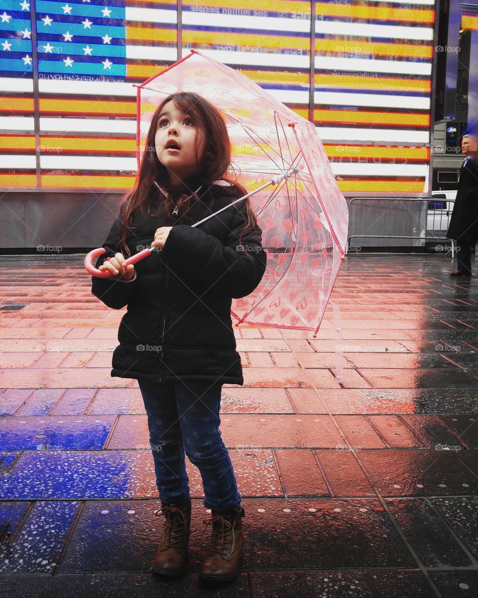 Portrait of little girl holding umbrella