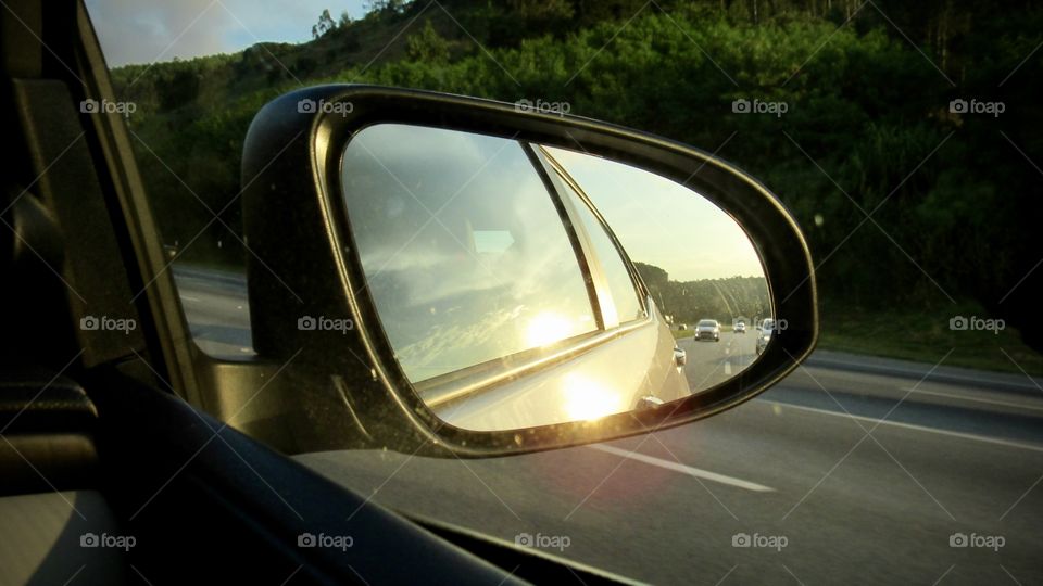 Looking in the rearview mirror of the car