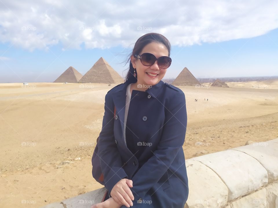 lovely smile with natural color photo and background panoramic view pyramids very beautiful.