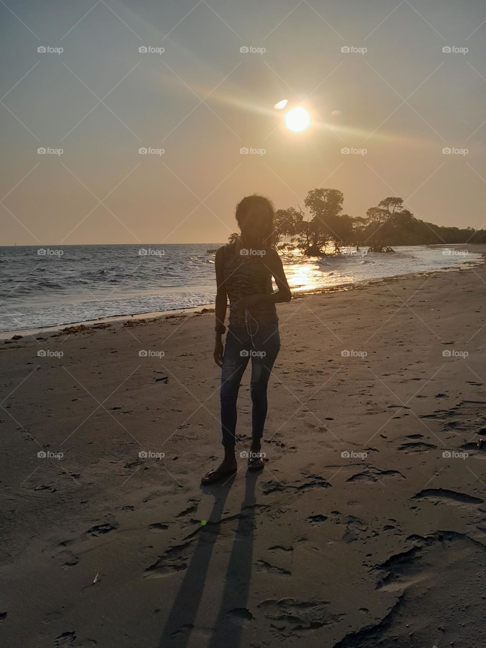 Sunset, beach, and a beauty, three in one scenery