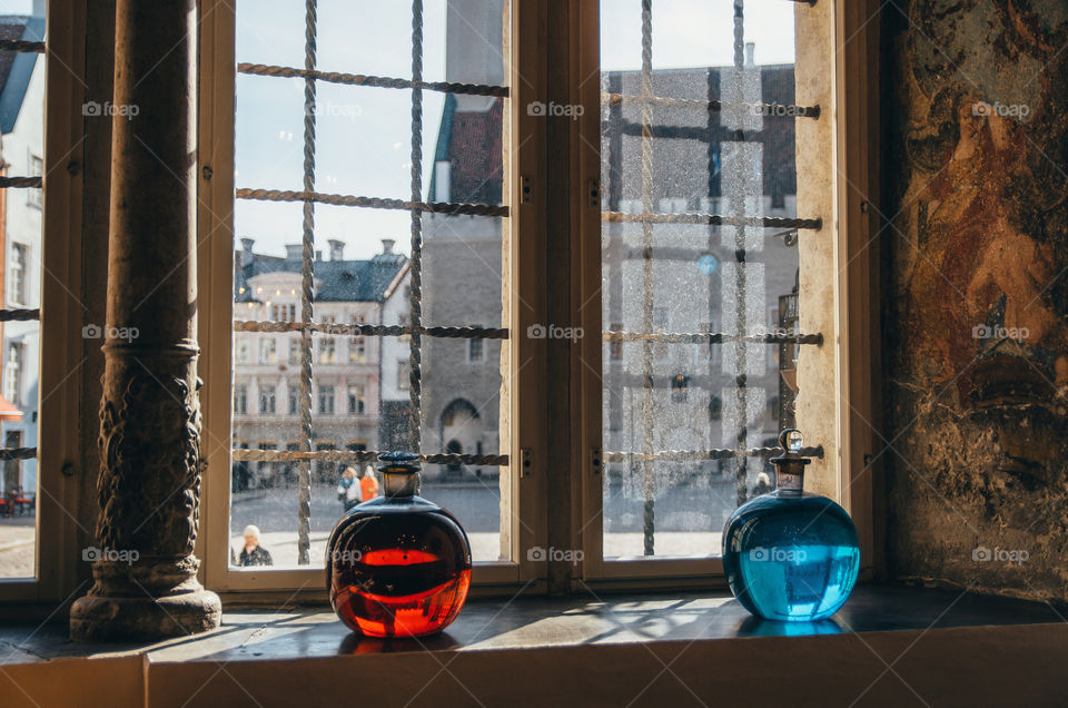 View of Town Hall Square from Raeapteek Pharmacy. Red and blue bottles in oldest pharmacy in Europe. Tallinn, Estonia