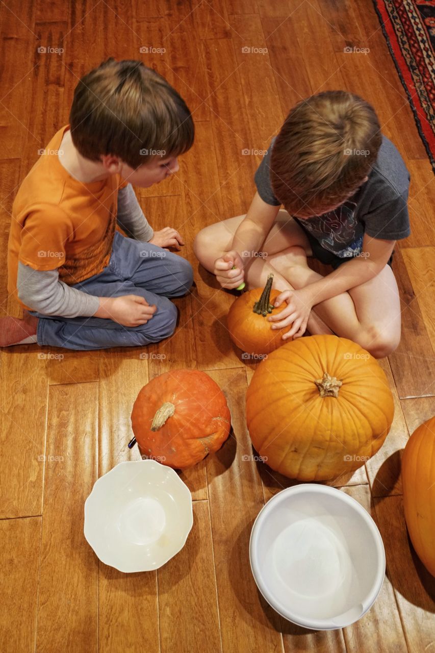 Young Boys Carving Halloween Pumpkins