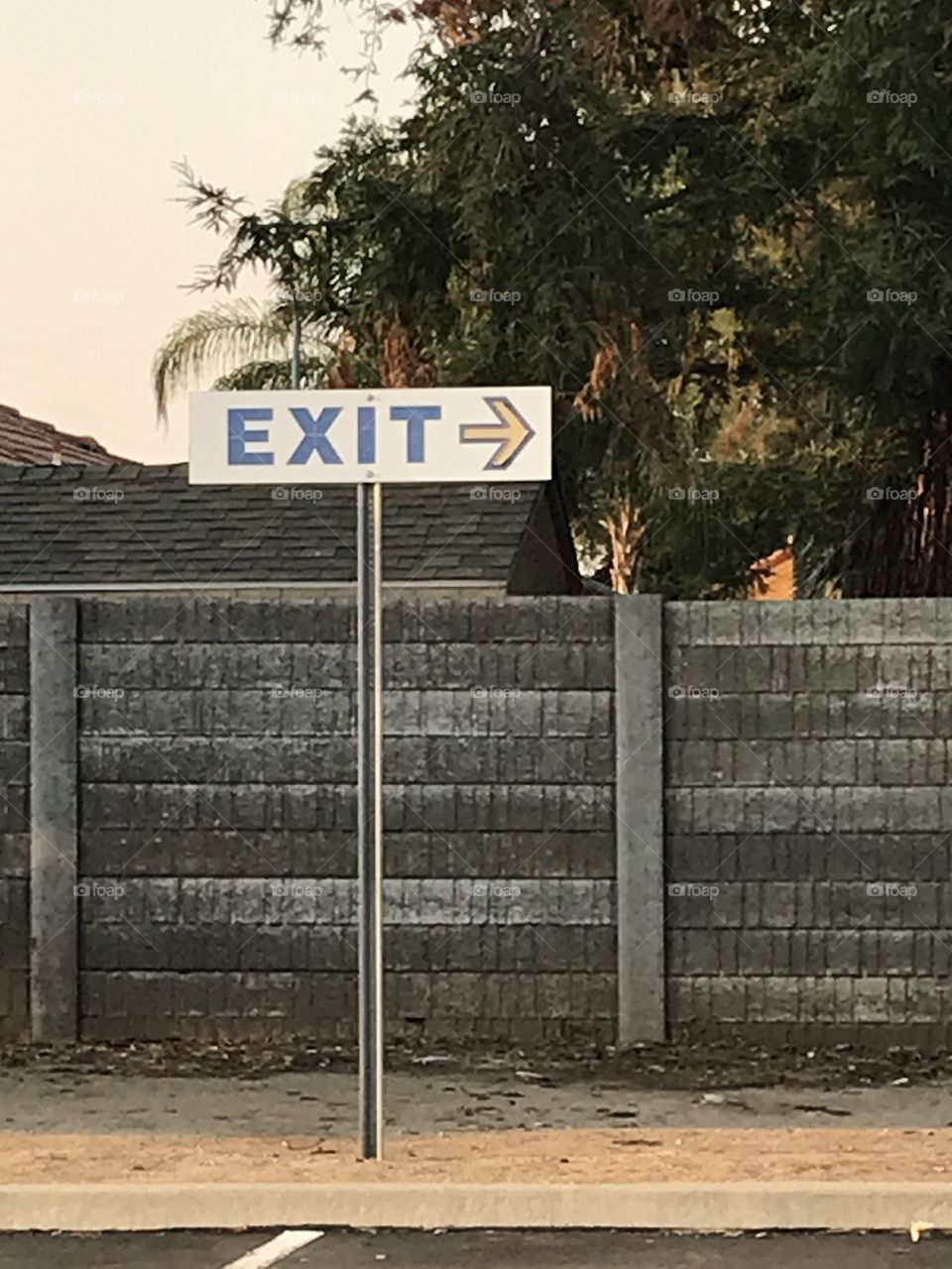 An exit sign showing how to leave the church parking lot.