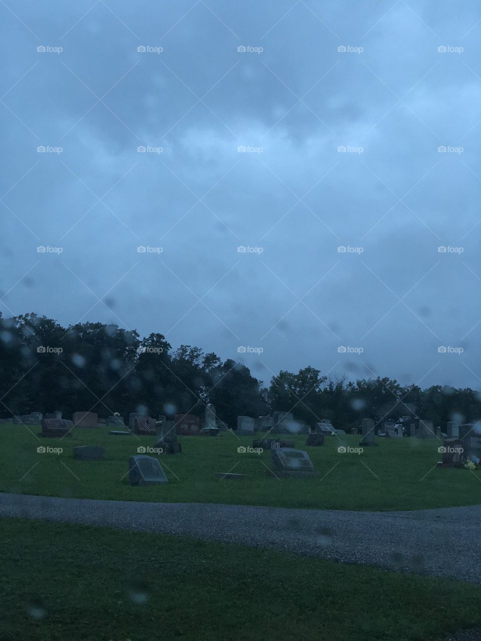 View of cemetery through rainy window